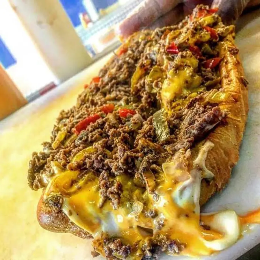 A Deezy's Famous cheesesteak loaded with chopped steak, peppers and melted cheese