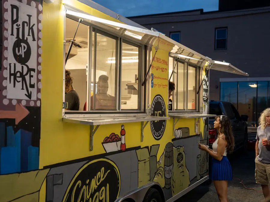 The Deezy's Famous food truck serving guests at an evening event
