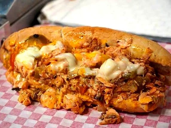 A Buffalo chicken cheesesteak in a checkered basket