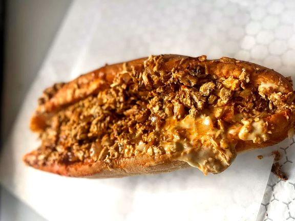 A Deezy's chicken cheesesteak on white paper