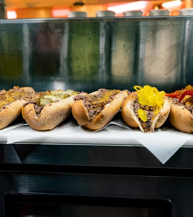 A line of Deezy's cheesesteaks on the grill
