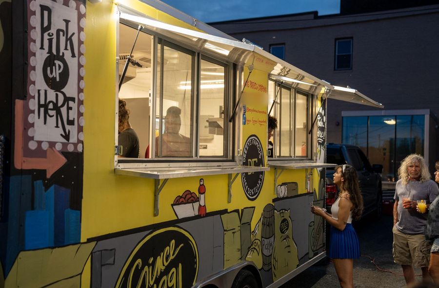 The Deezy's Famous food truck serving guests at an evening event